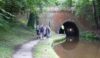 There is no lighting in the tunnel. Fortunately a handrail is in place.