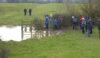 The walkers try to avoid getting stuck in the mud
