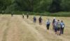 The group sprawls across the field as they prepare for another “slow steady incline”