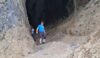 The walk leader emerges unscathed down the slippery rock