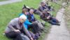 Sprawled on the bank eating lunch