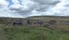 Walkers take their lunch on a drystone wall